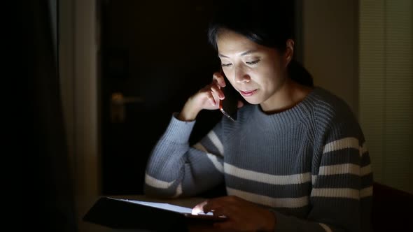 Woman use of digital tablet computer at night