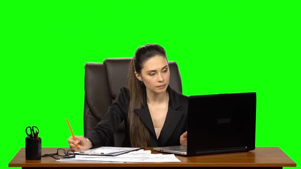 Female Manager Works on a Laptop, Think, Takes Notes Then Smile with Happy. Green Screen Background