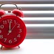 Red alarm clock ringing at twelve clock on background of blinds. - VideoHive Item for Sale