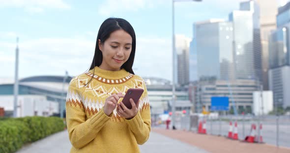 Woman use of smart phone in city