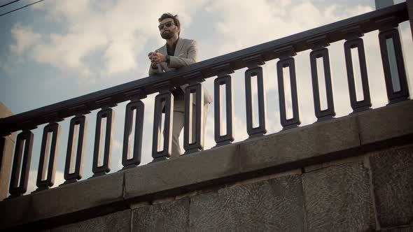 Lonely Handsome Confident Businessmen In Suit Stroll On City Bridge. Cheerful Businessman In Suit.