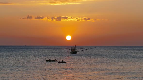 Fishing Boat in the Sea Against Sunset