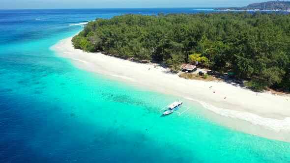 Daytime above abstract shot of a paradise sunny white sand beach and aqua blue ocean background in blue