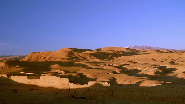Panning medium shot of desert landscape in Morocco