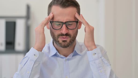 Portrait of Middle Aged Man Having Headache