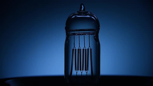 Electric Vintage Edison Light Bulb with a Spiral Flashing on a Blue Background