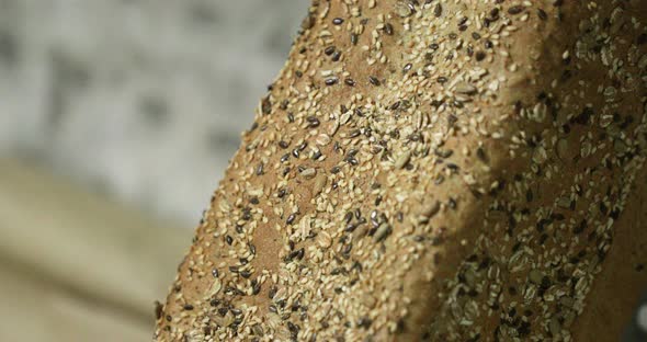 Freshly Baked Wheat Loaf Bread With Black And White Sesame Seeds In The Bakery. - close up shot, slo