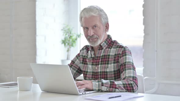 Ambitious Male Designer Looking at the Camera and Smiling