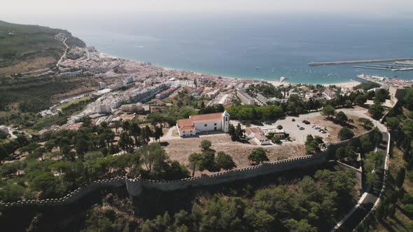 Castle of the Moors overlooking Sesimbra city and beach, Portugal. Panoramic aerial view
