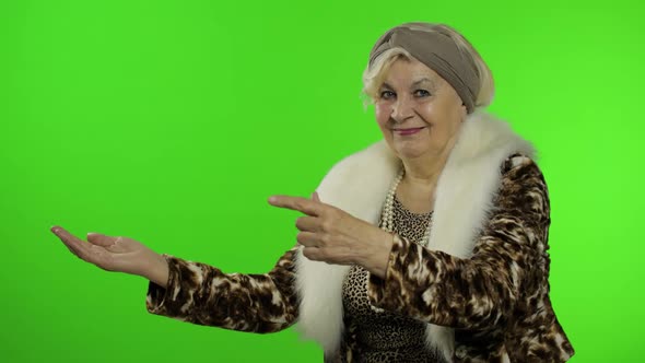 Elderly Caucasian Grandmother Woman Pointing at Something with Hand. Chroma Key