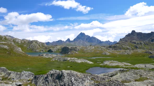 PAN: Idyllic blue alpine lake high up on the mountains, scenic landscape rocky terrain at high altit