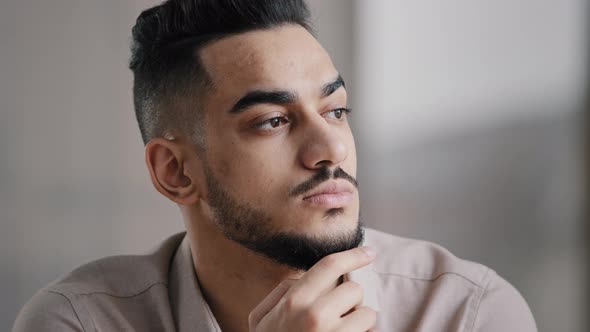 Pondering Serious Young Arabian Man Businessman Male Student Sit at Home Office Hold Hand on Chin