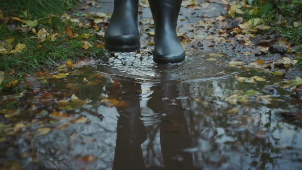 Woman In Boots Walking Along Country Path