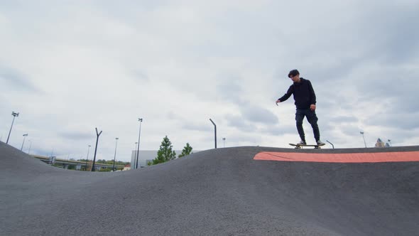 Guy Rides Skateboard on Asphalt Waves