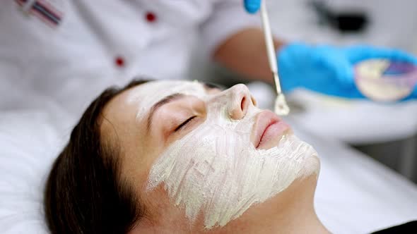 Doctor Cosmetologist or Dermatologist Making Face Mask in Cosmetology Salon
