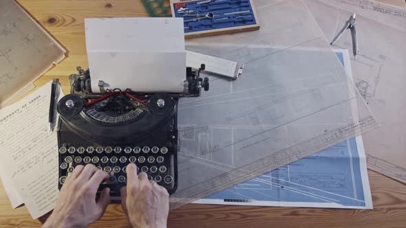 Vintage architecture desk with typewriter, blueprints and rulers