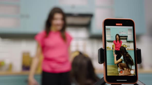 Two Young Girls Dancing Sing Having Fun and Filming Videos for Their Blogs or Social Networks