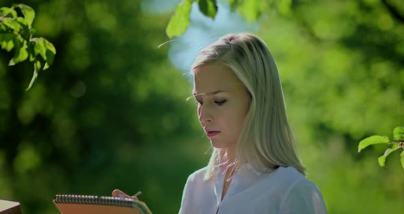 Pretty Girl Carefully Paints Nature