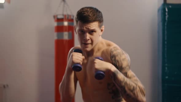 Young Boxer with Tattoos Does Shadow Fight