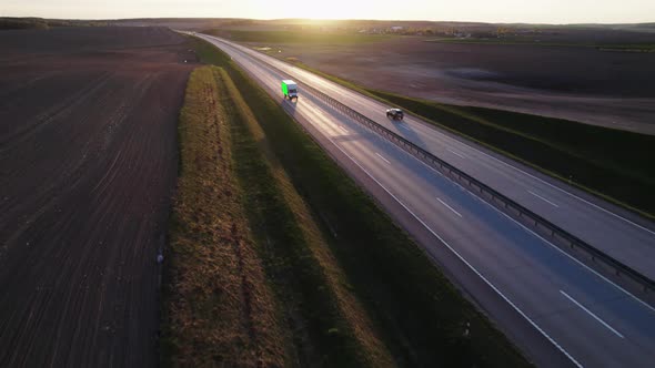 Cargo van with green screen and trackink markers on trailer drives along the highway.