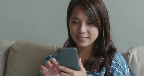 Woman look at mobile phone at home