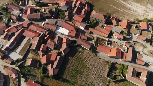 Aerial view of the village, lake, fields and forest in mountains