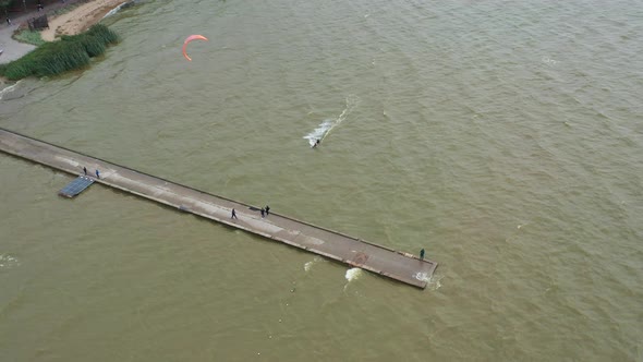 AERIAL: Surfer Swims Toward Stone Bridge and Stops at Very Last Second