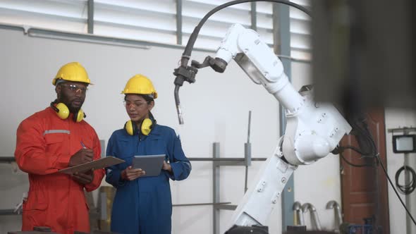 engineer cooperation male and female technician maintenance control relay robot arm
