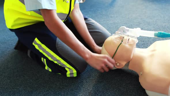 Woman exercising her first aid on a model