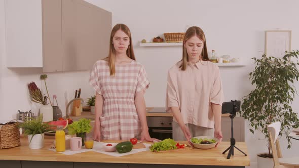 Happy Twin Sisters Posing in Kitchen