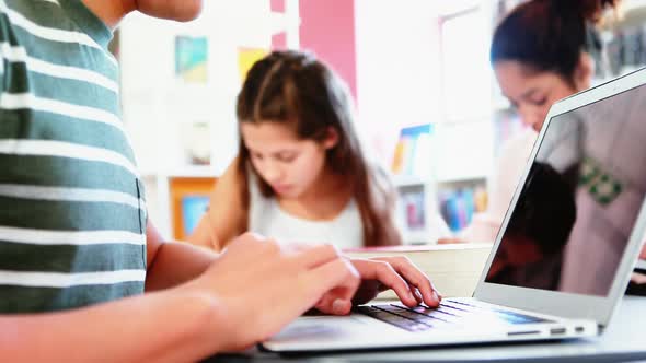 School kids doing homework in library