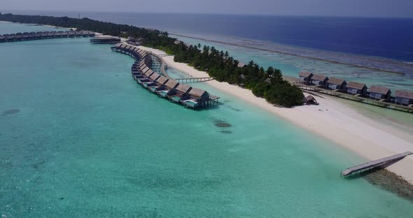 Luxury fly over travel shot of a sunshine white sandy paradise beach and aqua turquoise water backgr