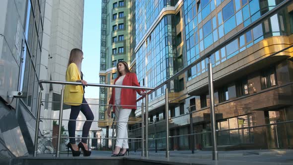 Two Business Women at Break, Talking on the Street.