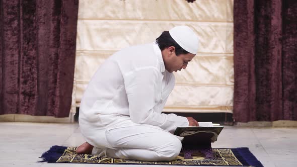Muslim man reading holy book Quran