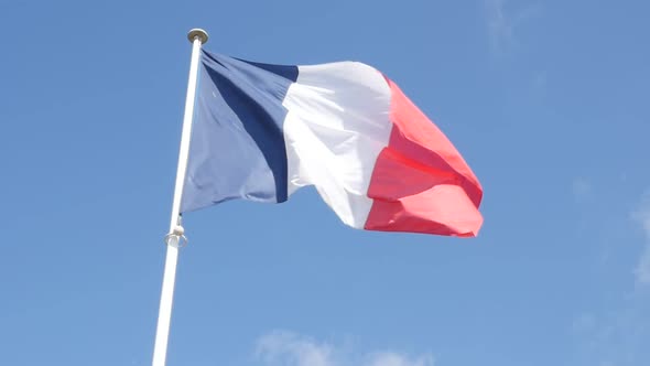 French flag in front blue sky slow waving on wind 1080p FullHD slow-mo footage - Flag of France and 