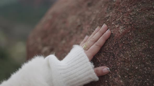 Crop Woman Touching Stone in Nature