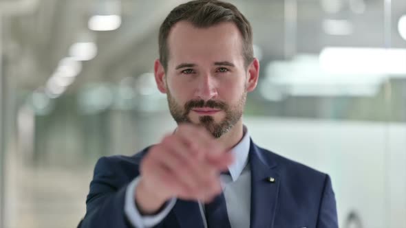 Portrait of Businessman with Pointing with Finger and Inviting