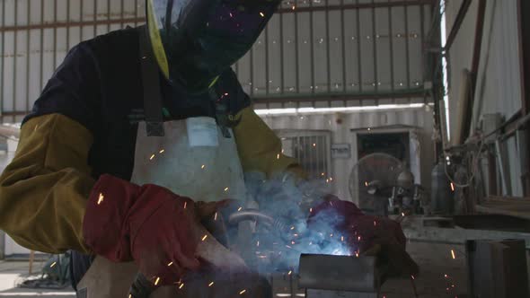 Slow motion of a welder welding construction steel frames