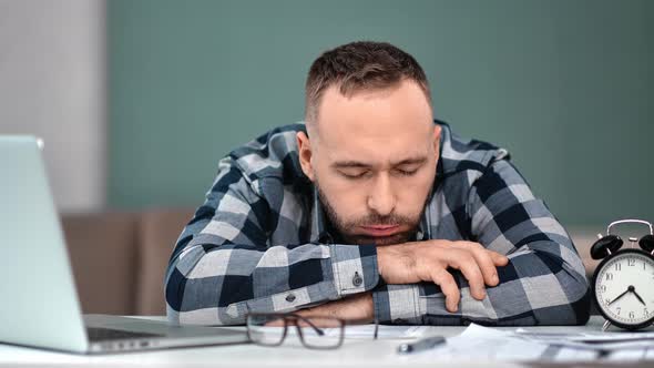 Tired Sleepy Man Suffering Headache at Workplace in Front of Laptop Pc