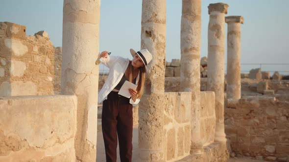 Competent Female Archeologist Standing Among Ruins of Ancient Temple