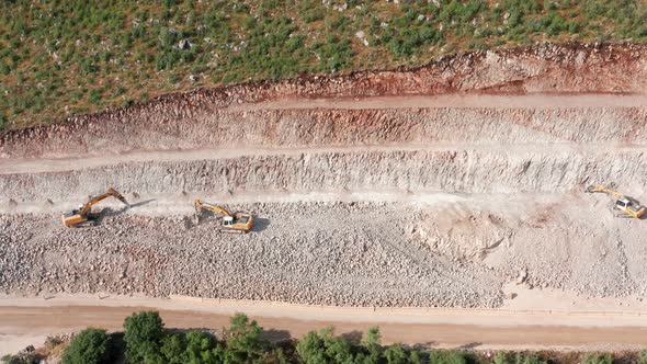 Sidehill cut on the road construction route or quarry. Removing rock and soil from the high side