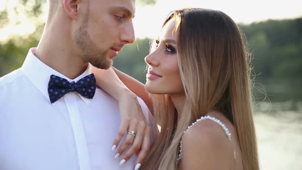 Loving Newlyweds Hugging on the Seaside Promenade