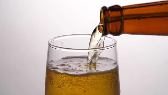 Beer Being Poured Into Translucent Glass