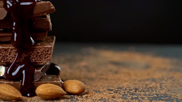 Yummy Sweets Still Life. Liquid Chocolate Being Poured Onto a Stack of Aerated Chocolate Pieces