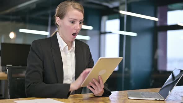 Disappointed Young Businesswoman Reacting To Loss on Tablet