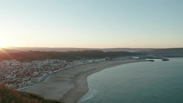 Medieval Urban Landscape By The Serene Ocean During Sunrise At North Beach (Praia do Norte) In Nazar