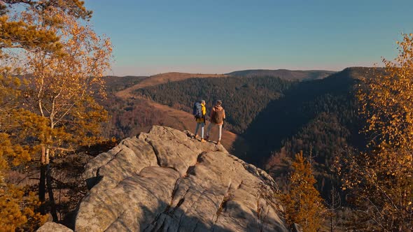 Aerial Footage From Drone Flying Over Couple Hikers Standing on Top of Cliff