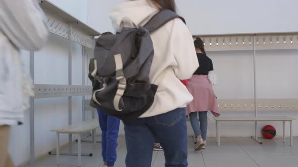 Teen Cheerleading Team Walking into Locker Room