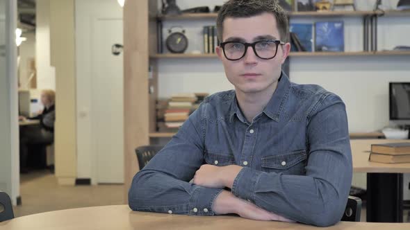 Creative Young Man in Glasses at Work Looking at Camera