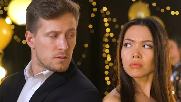 Anxious Multiracial Couple Suffering Misunderstanding at Party, Breakup Risk